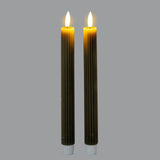 Pair of Hill Interiors Ribbed Taper Candles in beige wax with fine vertical ribbing and lit flames, shown upright against a plain grey background.