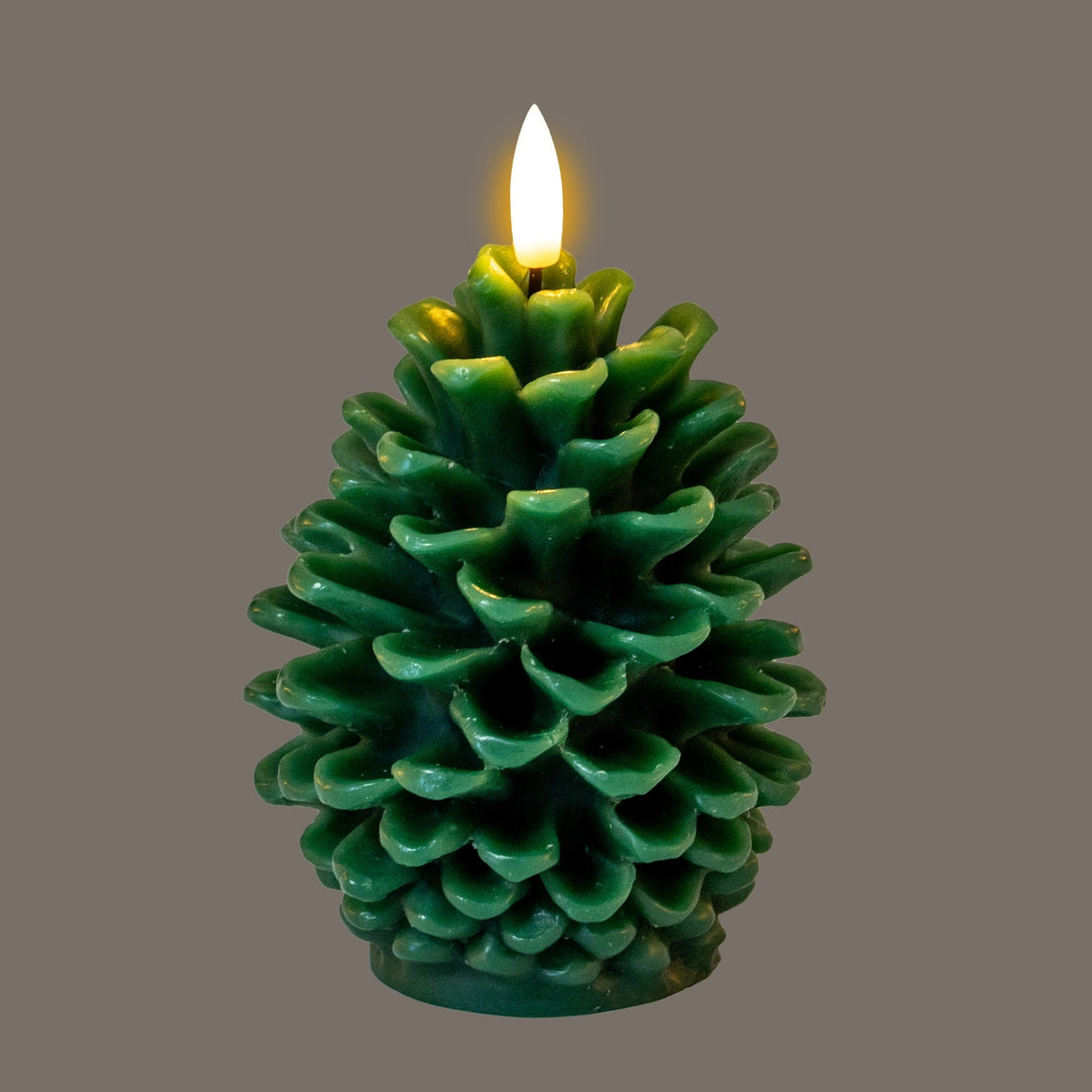 Hill Interiors Natural Glow LED wax candle shaped as a green textured pinecone with a flickering flame-effect tip, set against a grey background.