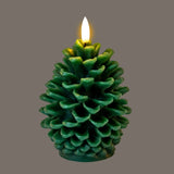 Hill Interiors Natural Glow LED wax candle shaped as a green textured pinecone with a flickering flame-effect tip, set against a grey background.