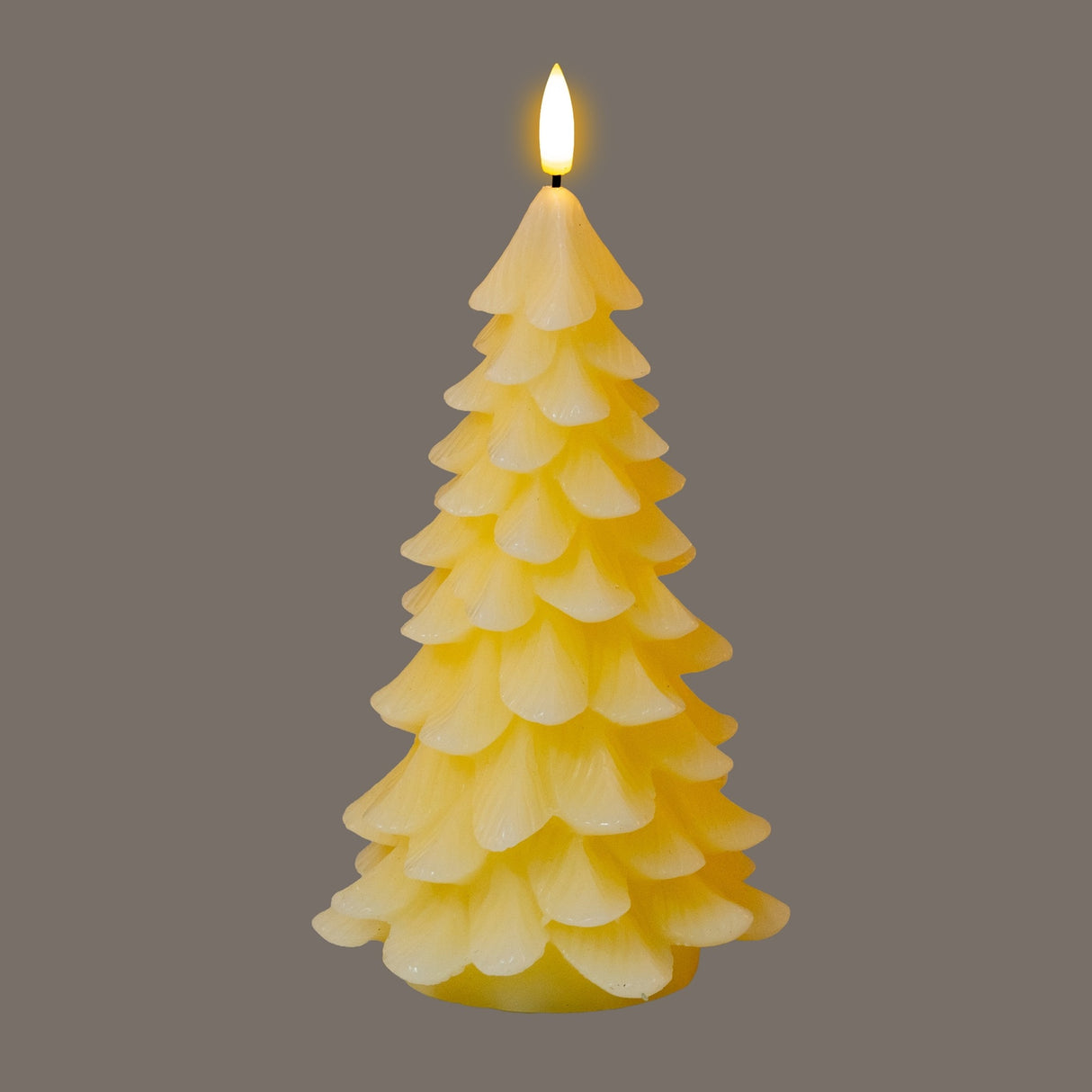 Hill Interiors Natural Glow LED Wax Tree Candle in beige, moulded as a layered fir tree with a flickering flameless LED flame at the tip.