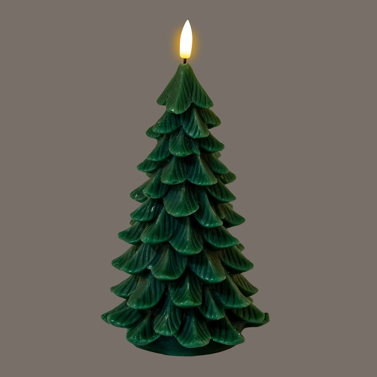 Hill Interiors Natural Glow Tree LED wax candle shaped as a layered green fir with a flickering faux flame at the tip, on a grey background.