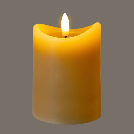 Hill Interiors Natural Glow beige LED pillar candle with melted-wax plastic finish and flickering amber flame on a grey background.