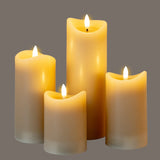 Hill Interiors Natural Glow Melted LED Pillar Candles in beige plastic with flickering flames, grouped at varying heights on a grey background.