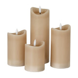 Hill Interiors Natural Glow beige LED pillar candles in four varying heights with melted-edge tops and white flickering flames on a plain background.