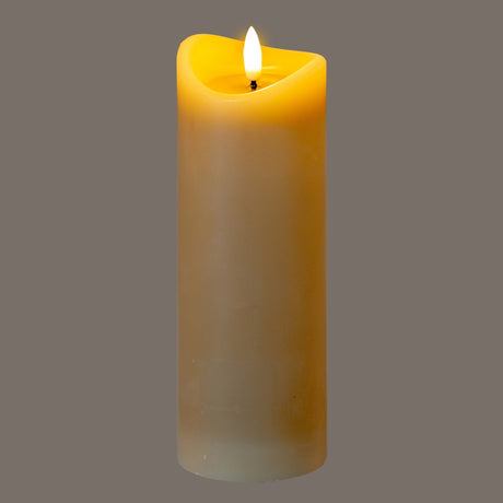 Hill Interiors Natural Glow melted LED pillar candle in beige plastic with a flame-like glow and dipped top edge, shown on a grey background.