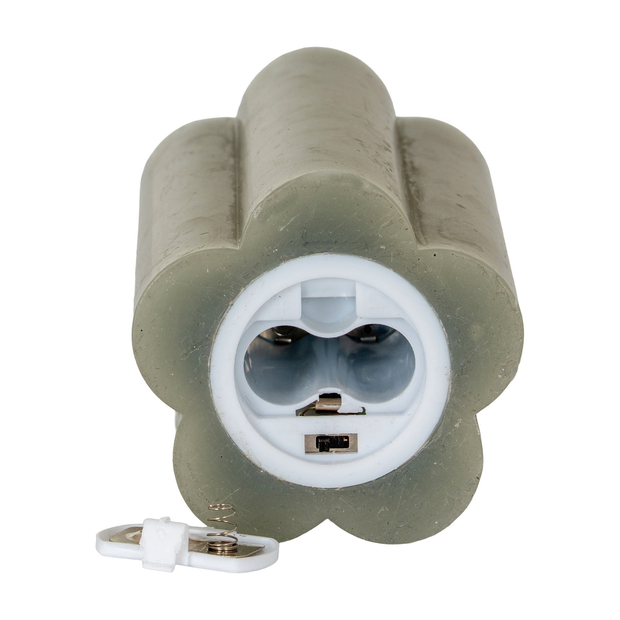 Base view of Hill Interiors Natural Glow beige LED pillar candle showing the battery compartment opening and detached cover with spring contact.
