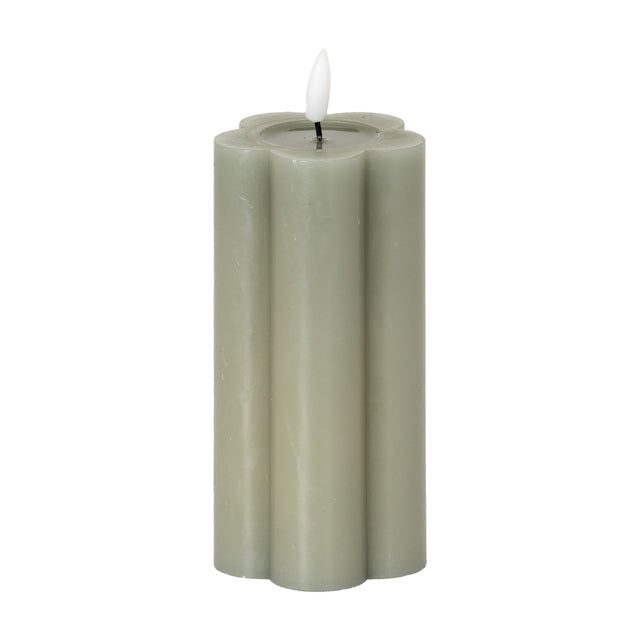 Hill Interiors Natural Glow LED pillar candle in beige with a scalloped flower-shaped profile and moulded flame, shown on a plain white background.