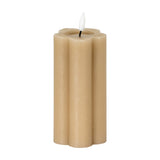 Hill Interiors Natural Glow beige LED pillar candle with a scalloped stone effect body and flickering flame-shaped tip, shown on a plain white background.
