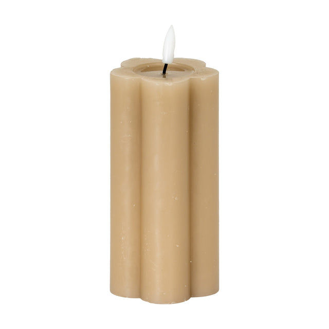 Hill Interiors Natural Glow beige LED pillar candle with a scalloped stone effect body and flickering flame-shaped tip, shown on a plain white background.