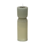 Hill Interiors Natural Glow carved LED pillar candle in beige, with ribbed plastic surface and flickering flame-shaped tip, shown on a white background.