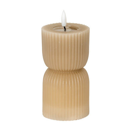 Hill Interiors Stone Carved LED Pillar Candle in beige with ribbed hourglass form and flickering flame-effect tip, shown on a plain white background.