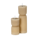 Hill Interiors Stone Carved LED Pillar Candles in beige, shown as two ribbed pillar forms of differing heights with flameless LED tips on a white background.