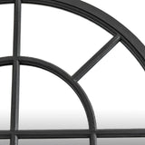 Close-up of Hill Interiors Black Wood Arched Window Mirror showing the black wooden frame's curved top section and segmented pane grid.