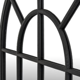 Close-up of the Hill Interiors Black Wood Arched Window Mirror showing the black wooden frame, arched top and grid of glass panes.