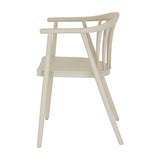 Hill Interiors Moulded Plastic Accent Chair in beige, side view showing curved spindle back, armrests and splayed legs on a white background.