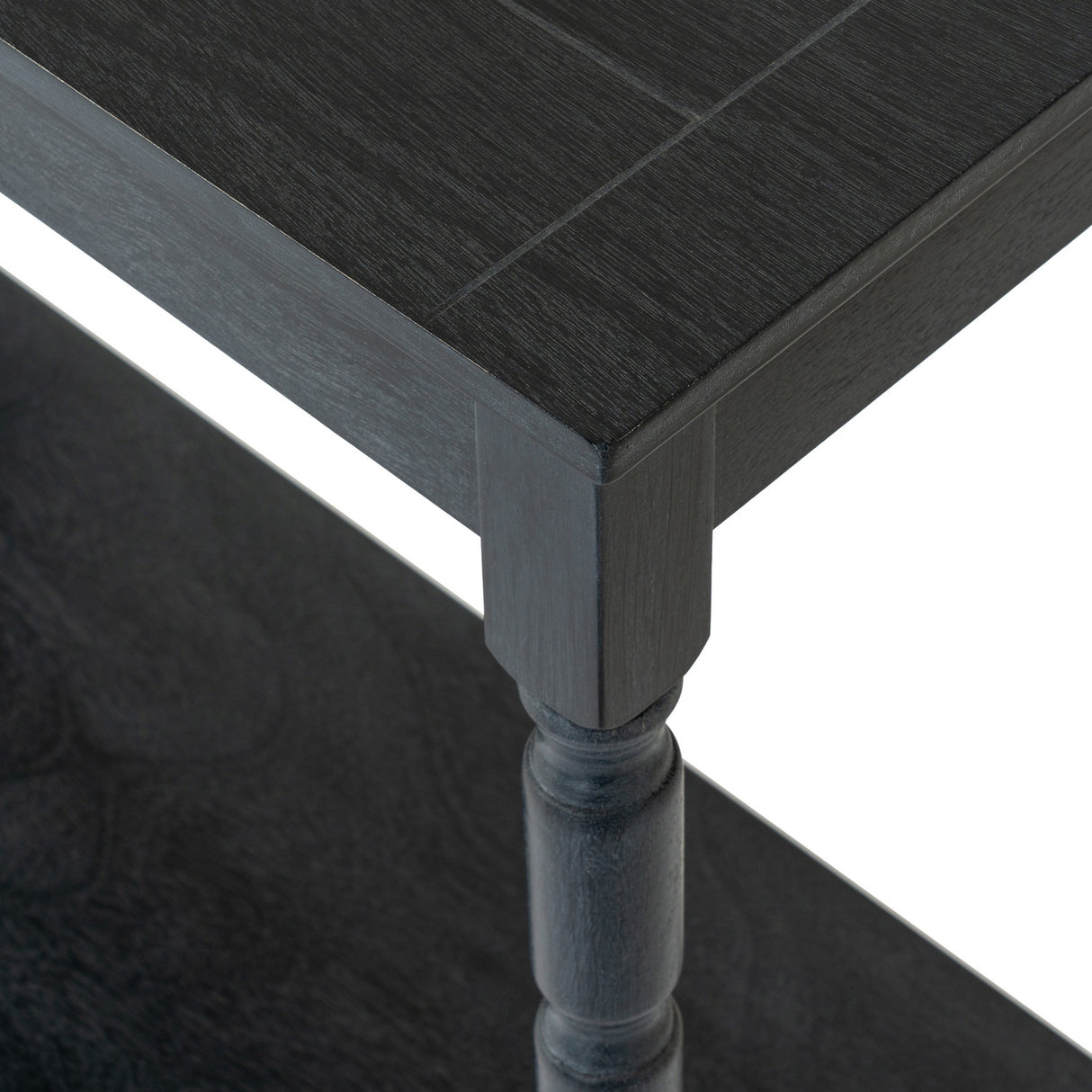 Close-up of Hill Interiors Contoured Wooden Console Table in black, showing the grained top edge and turned wooden leg detail.