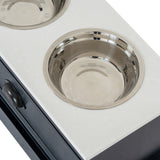 Close-up of the Hill Interiors Wooden Pet Feeder Table in black, showing a recessed stainless steel bowl set into the white top above a drawer.