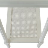 Close-up of Hill Interiors Large Rattan Console Table in white, showing the woven rattan lower shelf panel framed by turned wooden legs.