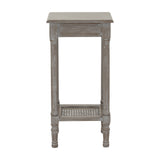 Hill Interiors Small Rattan Side Table in grey, shown from the side with tall turned wood legs and a woven rattan lower shelf on a white background.
