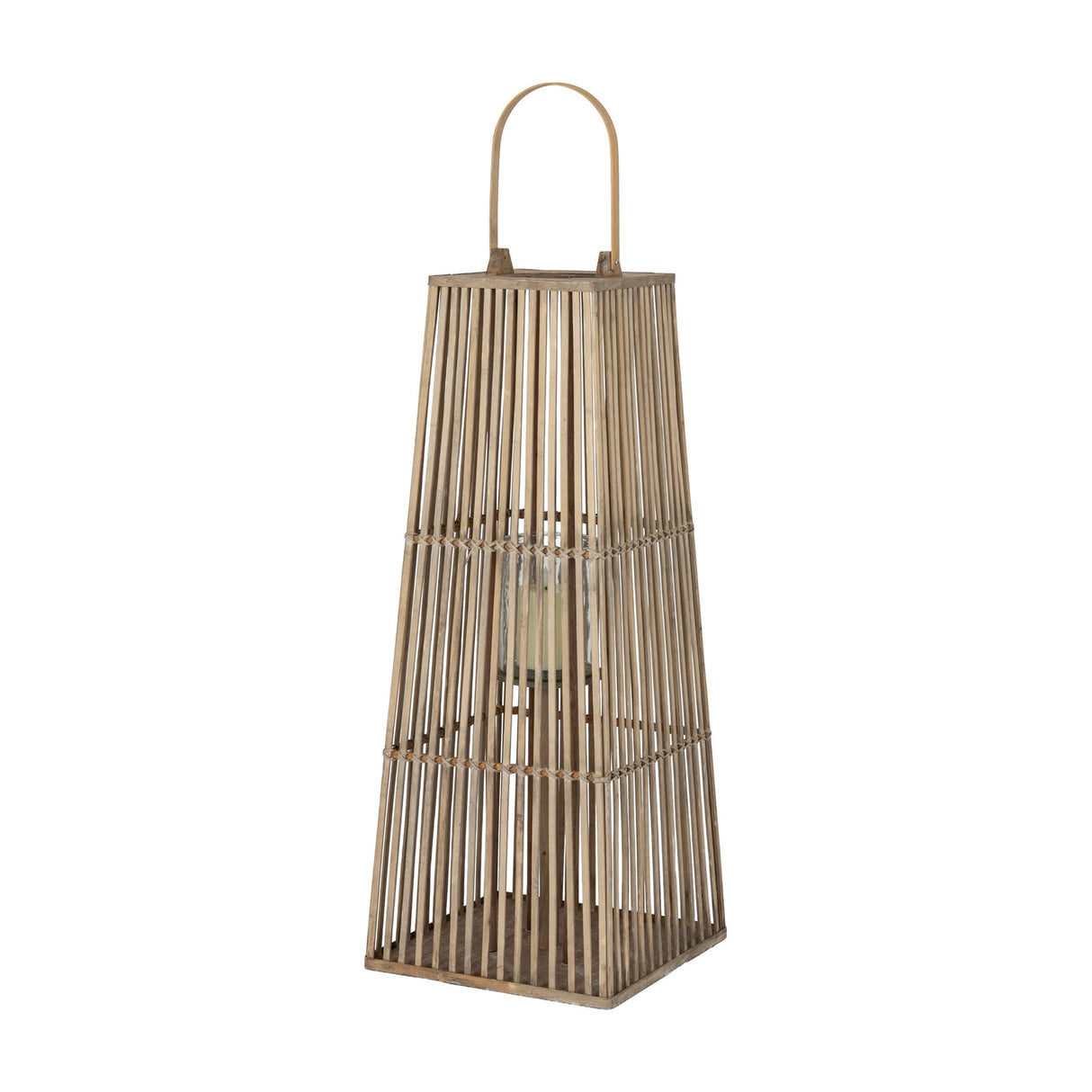 Hill Interiors large brown wicker lantern with tapered woven frame, arched handle and inner glass holder with pillar candle, on a plain background.