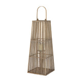 Hill Interiors large brown wicker lantern with tapered woven frame, arched handle and inner glass holder with pillar candle, on a plain background.