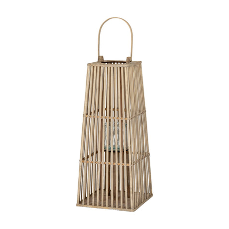 Hill Interiors Medium Wicker Lantern in brown with a tapered silo frame, arched handle and inner glass candle holder, shown on a plain white background.