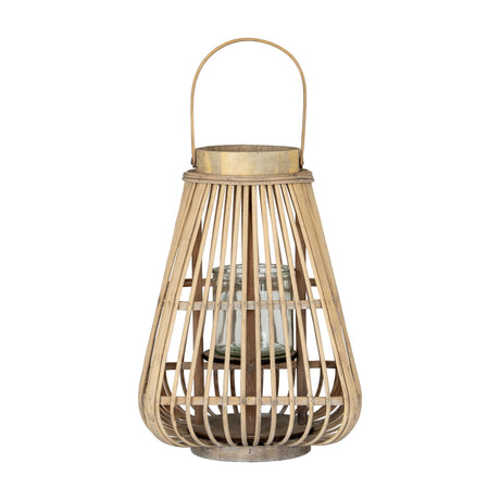 Hill Interiors Medium Wicker Lantern in brown with tapered woven frame, arched handle and clear glass candle holder inside, on a white background.