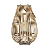 Hill Interiors Medium Ellipse Wicker Lantern in brown with vertical slatted frame, rope handle and clear glass holder with pillar candle, on white.