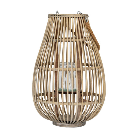 Hill Interiors Large Ellipse Wicker Lantern in brown, tall teardrop shape with rope handle and glass pillar candle holder inside, on a plain white background.