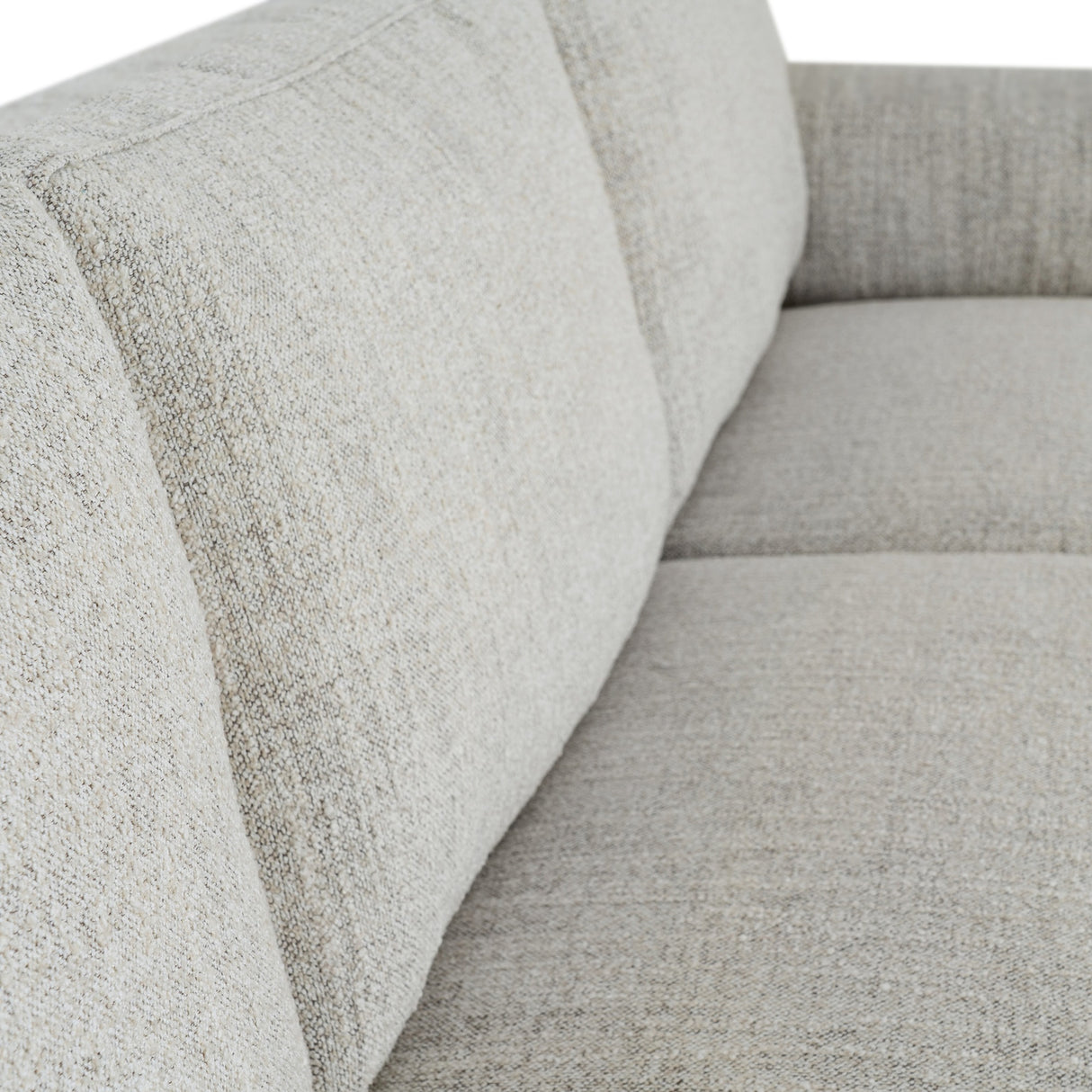 Close-up of the Hill Interiors Vaxeer Three Seater Sofa in white, showing the textured upholstery across the backrest and seat cushion.