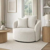 Marlenza Swivel Accent Chair in white textured upholstery with rounded arms and matching cushions, styled in a bright neutral living room by a window.
