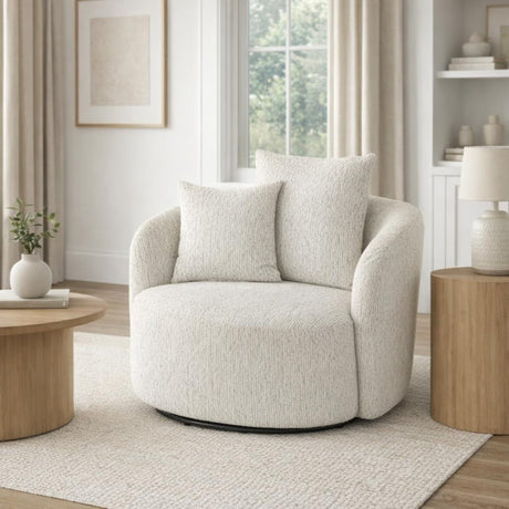 Marlenza Swivel Accent Chair in white textured upholstery with rounded arms and matching cushions, styled in a bright neutral living room by a window.
