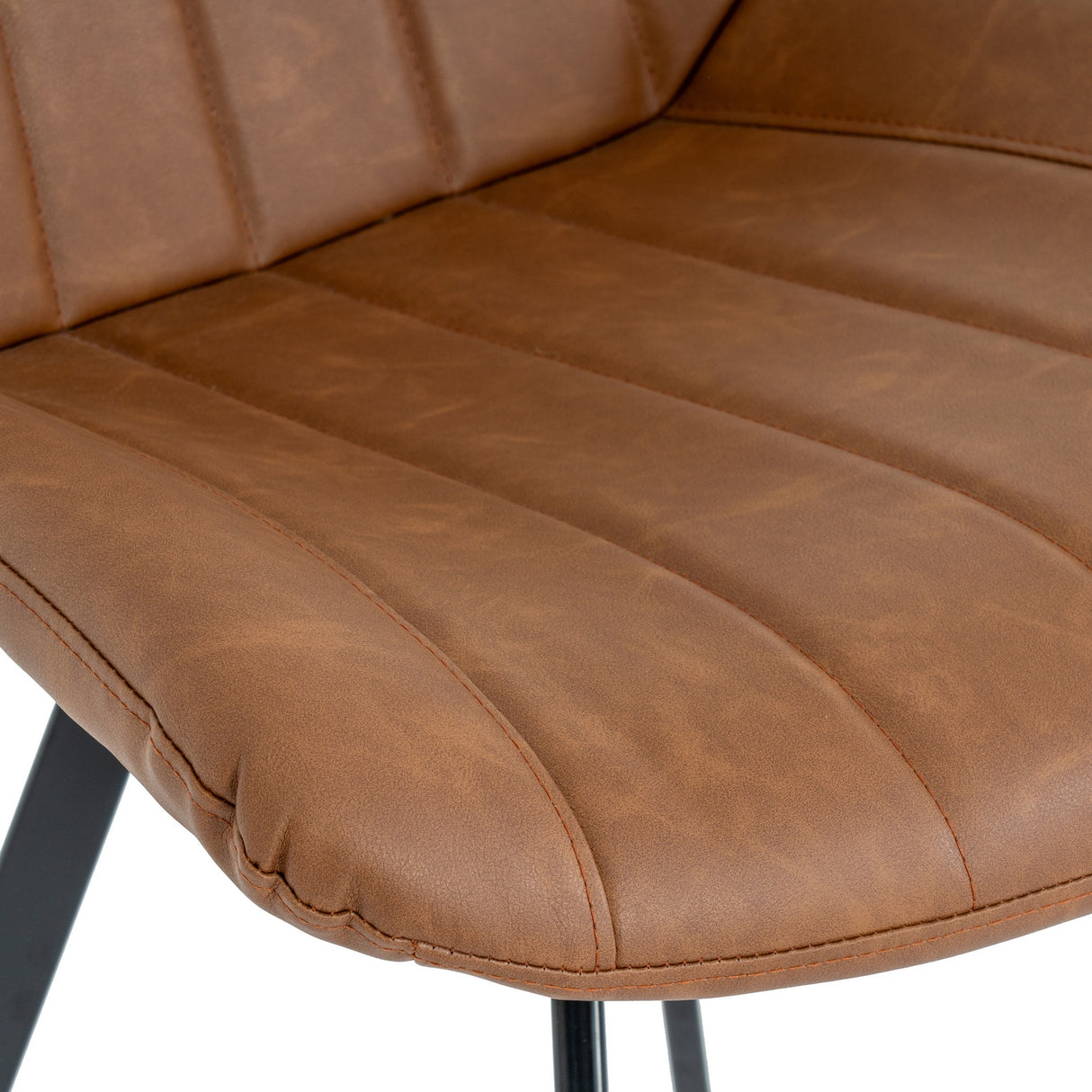 Close-up of the Hill Interiors Draxinby Swivel Dining Chair in tan, showing ribbed stitching on the upholstered seat and back with a black metal leg.