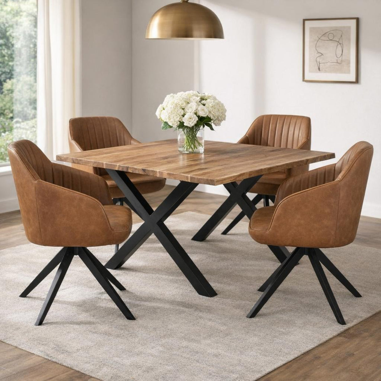 Hill Interiors Tan Metal Accent Chair with tan leather-look upholstery and black splayed legs, set with three matching chairs around a wooden dining table.