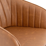 Close-up of the Hill Interiors Tan Metal Accent Chair showing vertical channel stitching on the brown worn-leather-look backrest and curved seat.