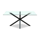 Hill Interiors Vestamby rectangular dining table with a clear tempered glass top on a black crossed metal base, shown on a plain white background.