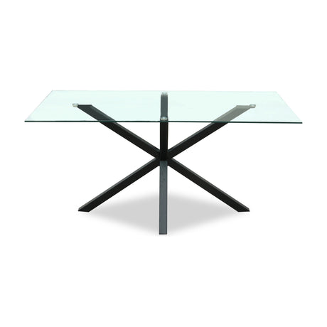 Hill Interiors Vestamby rectangular dining table with a clear tempered glass top on a black crossed metal base, shown on a plain white background.