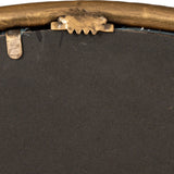 Close-up of the Hill Interiors Sillura round mirror's backing, showing the gold dimpled frame edge with sawtooth hanger and metal retaining clip.