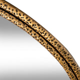 Close-up of the Hill Interiors Sillura round wall mirror showing its dimpled, textured gold frame and clear glass edge against a white background.