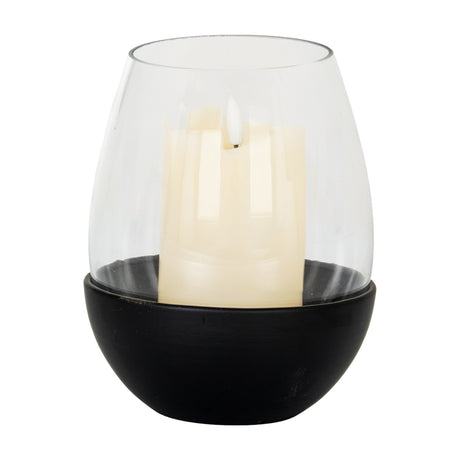 Hill Interiors large candle holder with clear glass goblet on a rounded matte black base, holding a cream pillar candle, shown on a white background.