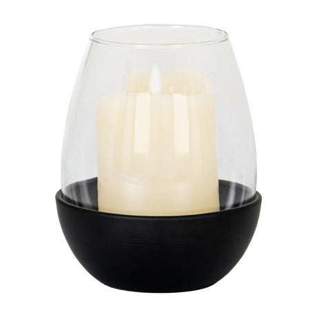 Hill Interiors medium candle holder with rounded matte black base and clear glass goblet holding an ivory pillar candle, on a white background.