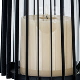 Close-up of Hill Interiors Large Lantern with black metal bars, clear glass panel and ivory pillar candle seated on the base.