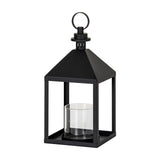 Hill Interiors medium black metal lantern candle holder with pyramid top, ring handle and clear glass pillar holder inside, on a white background.