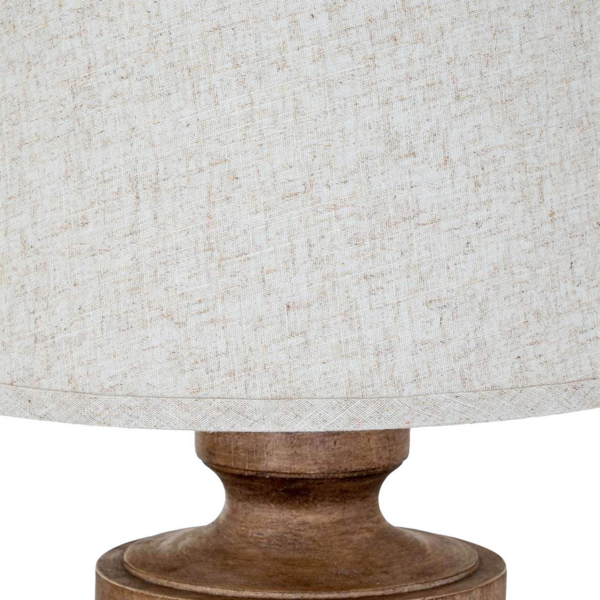 Close-up of the Hill Interiors Table Lamp with Edged Linen Shade in brown, showing the textured natural linen drum shade and turned resin base detail.