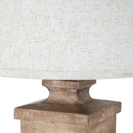 Close-up of the Hill Interiors Table Lamp showing the edged linen shade in natural cream tones above a moulded resin base with a soft brown, stone-like finish.