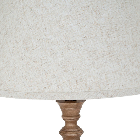 Close-up of the Hill Interiors Table Lamp With Edged Linen Shade in brown, showing the neutral linen shade edging and turned resin base detail.