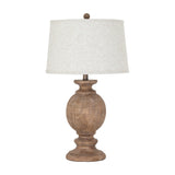 Hill Interiors table lamp with a sculpted brown resin baluster base and tapered edged linen shade, shown on a plain white background.