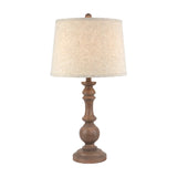 Hill Interiors Velantha table lamp with a sculptural turned brown resin base and edged linen drum shade, shown on a plain white background.
