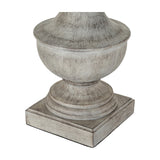 Close-up of the Hill Interiors Table Lamp base, showing a sculpted white resin pedestal with urn shape on a square plinth against a plain white background.
