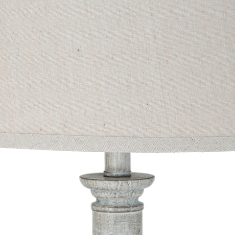 Close-up of the Hill Interiors Table Lamp with Linen Shade, showing the natural linen drum shade and distressed white moulded resin base.